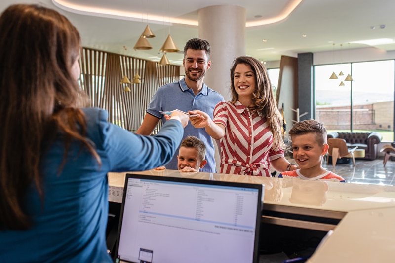 family checking in to hotel