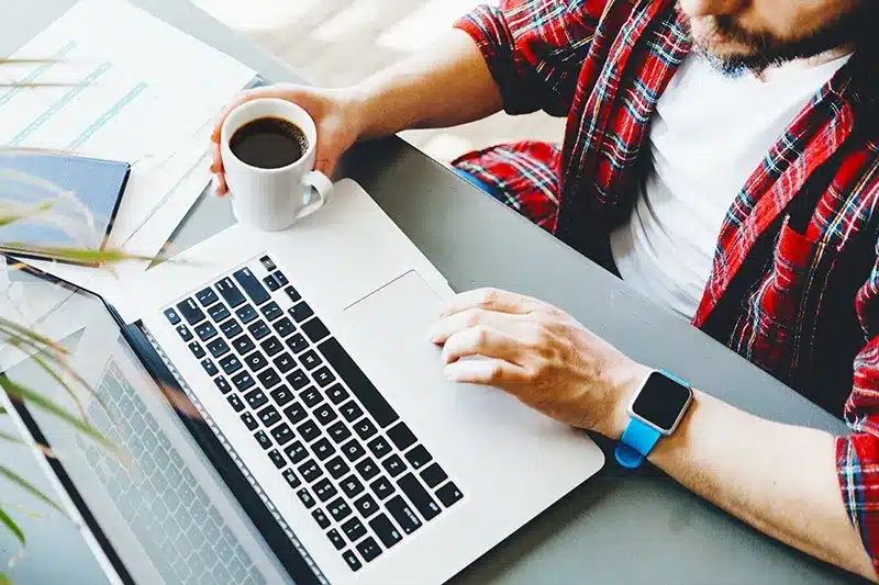 guy in flannel looking at laptop
