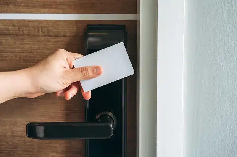 hand holding key card near lock handle