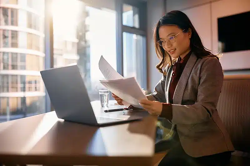 lady reviewing reports while sitting at desk
