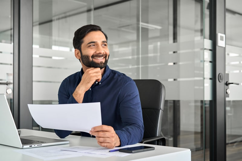 man working on billing with a comoputer
