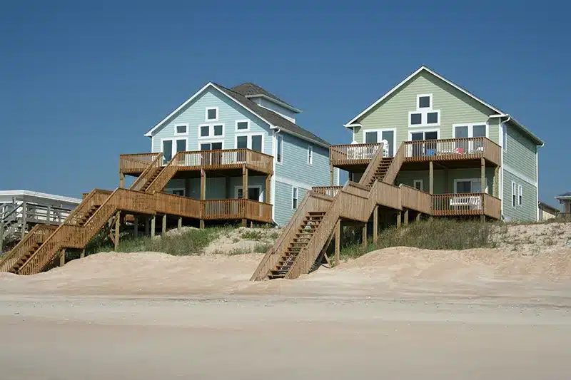 two beach houses on the sand