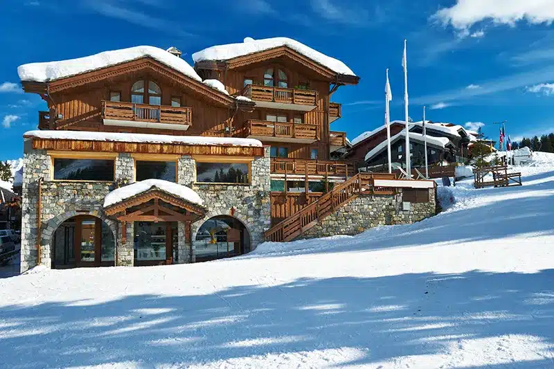 wood clad mountain retreat in the snow