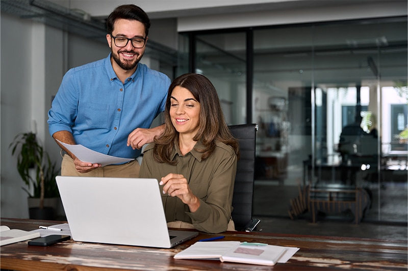 people using laptop and smiling