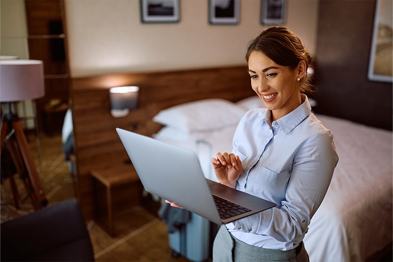 woman using laptop in hotel room
