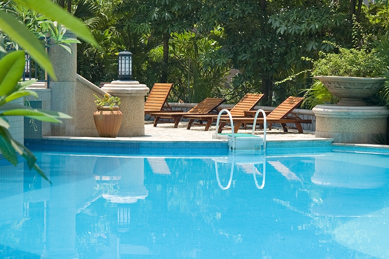 resort pool with reclining chairs